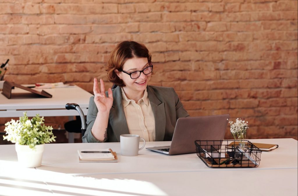 A person sitting in front of laptop during virtual interview