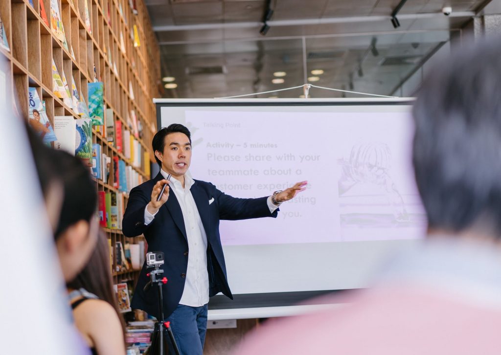 Public speaking, a facilitator delivering a presentation.
