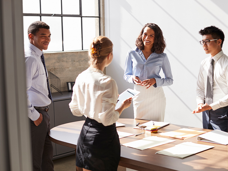 A group of people communicating on a round table