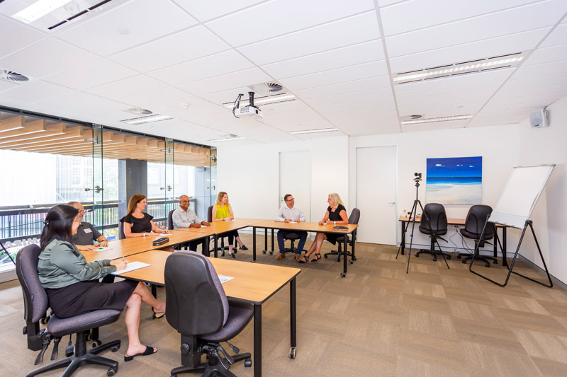 ATI-Mirage team members in a large ATI-Mirage conference room.