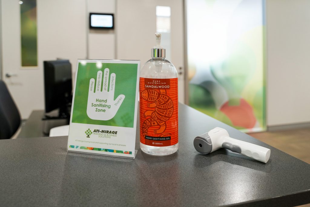 ATI-Mirage reception with COVID-19 hand sanitising zone sign, hand sanitiser and temperature checking device