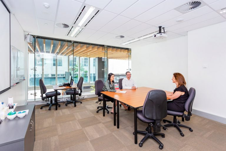 ATI-Mirage team members in a small ATI-Mirage conference room.