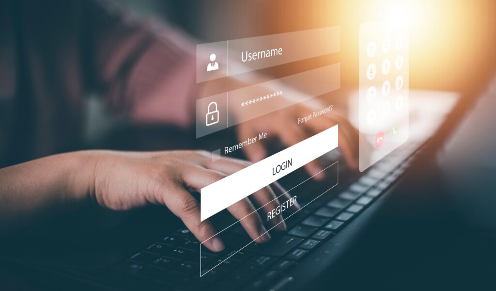 image of a person's hands typing their login details on a screen, representing cyber security