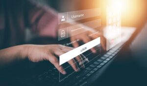image of a person's hands typing their login details on a screen, representing cyber security