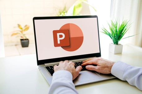 A person opening the Microsoft PowerPoint on their laptop