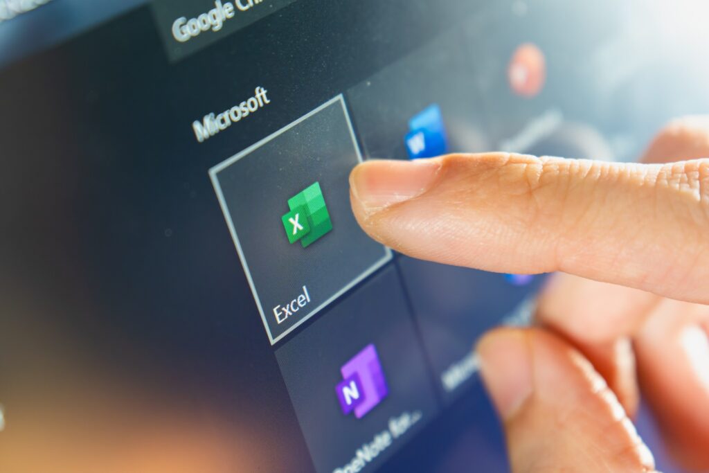 A person touch the Microsoft Excel app icon