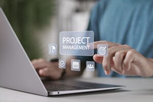 Zoom in of a person hand typing on the laptop with Project Management mind map floating in the middle.